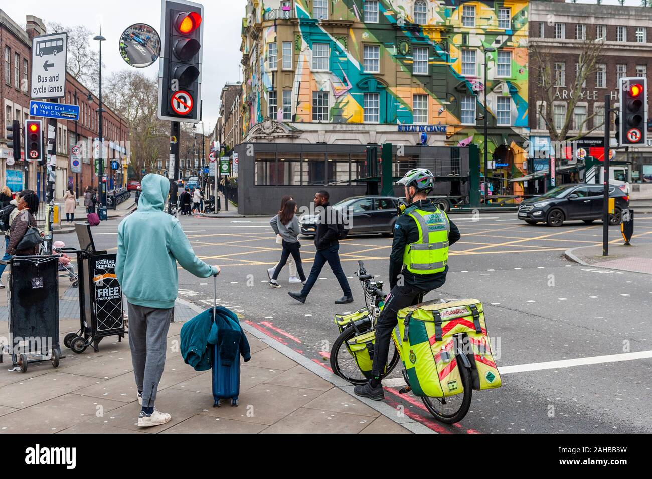 London Ambulance Paramedic on a push bike stopped at traffic lights near Kings Cross Station, London, UK. Stock Photo