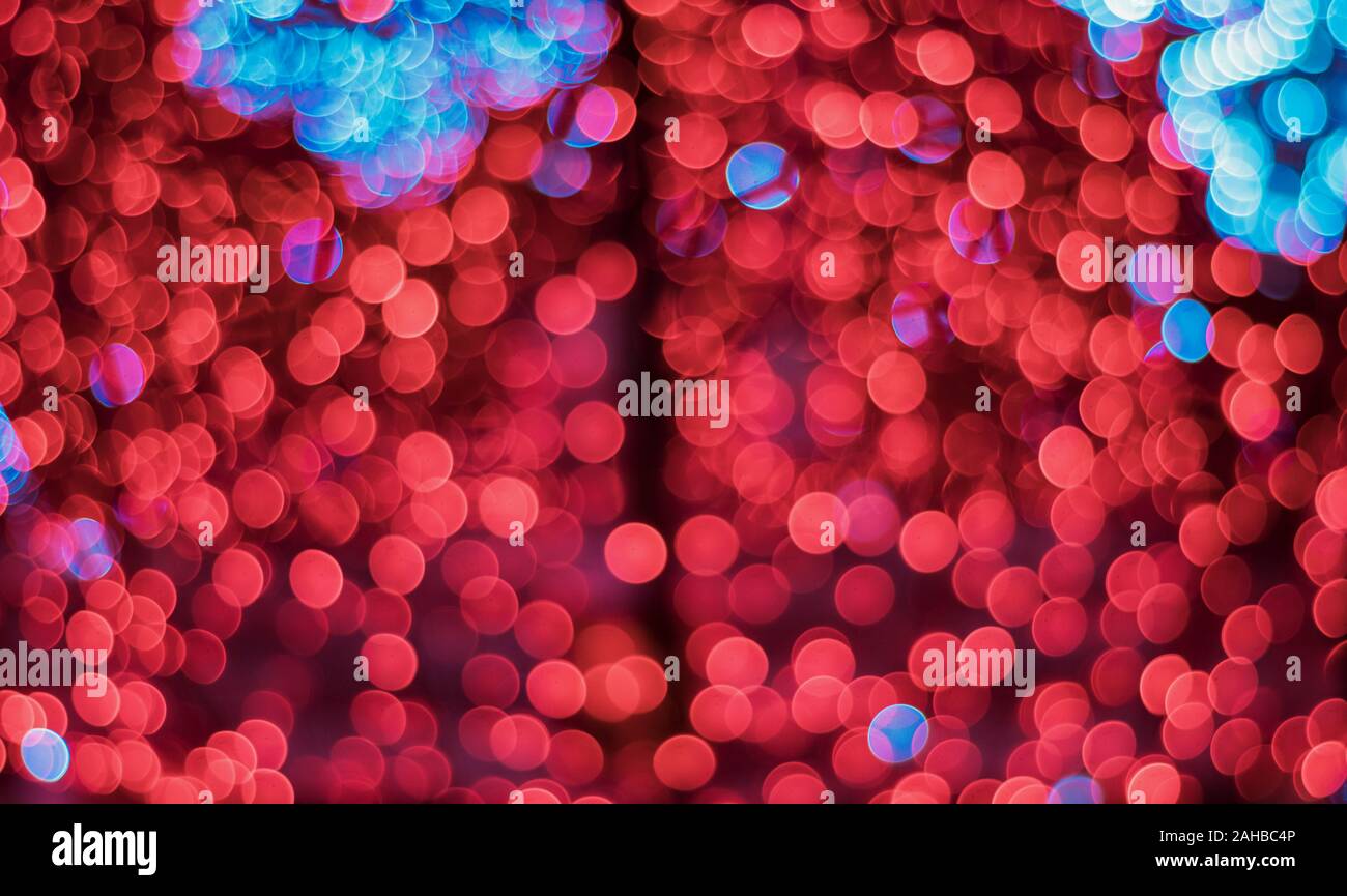 Red and blue glitter with bokeh effect and selective focus. Festive background with bright red and blue lights, red bubble, blue bubble Stock Photo