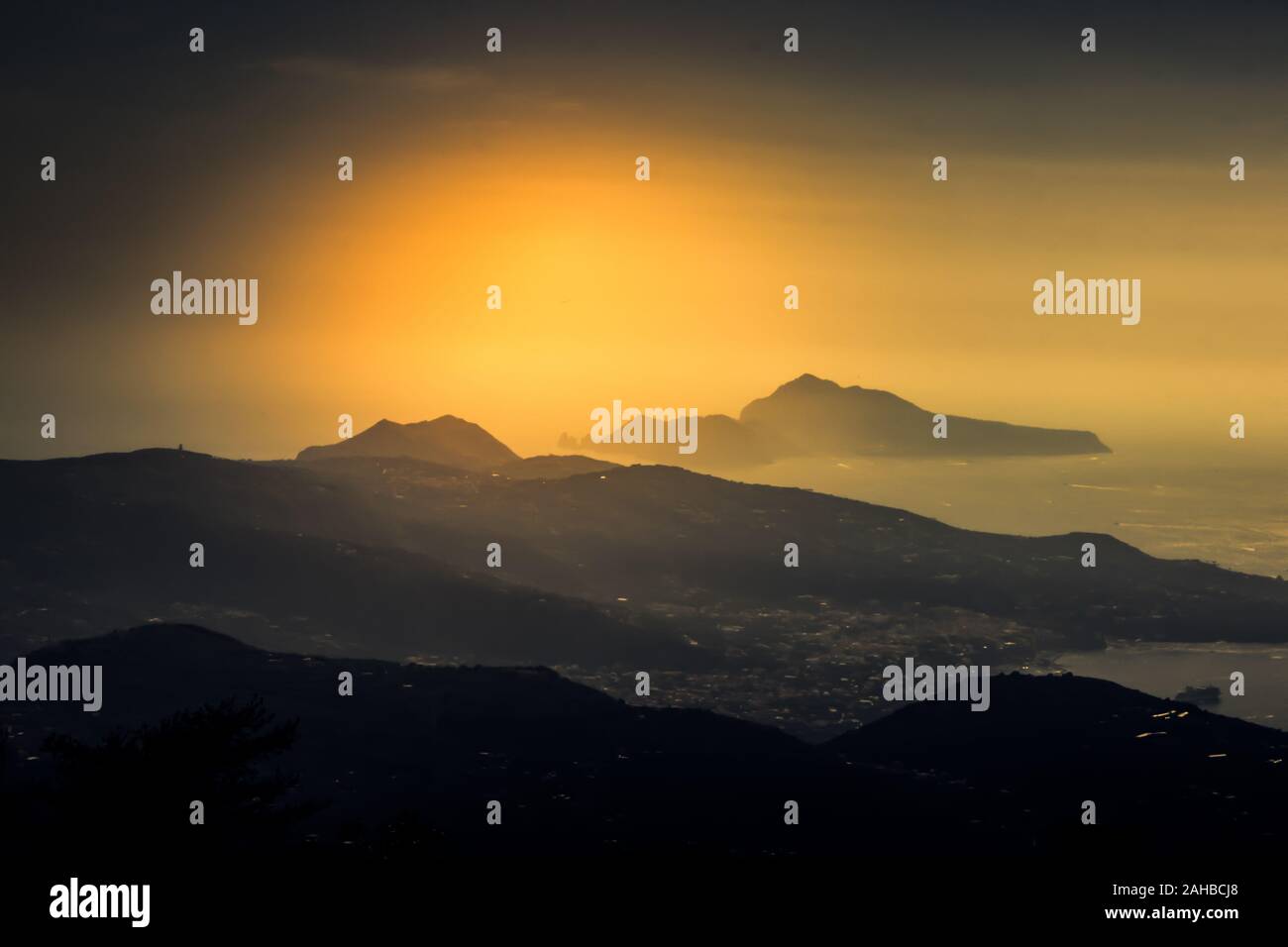 Scenic aerial sunset seascape over Gulf of Naples, Capri island and mountains Lattari, Amalfi coast, Campania, Italy. Stock Photo