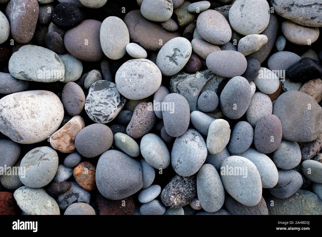 Pebbles and stones, various sizes and shapes, various minerals, close view. Stock Photo