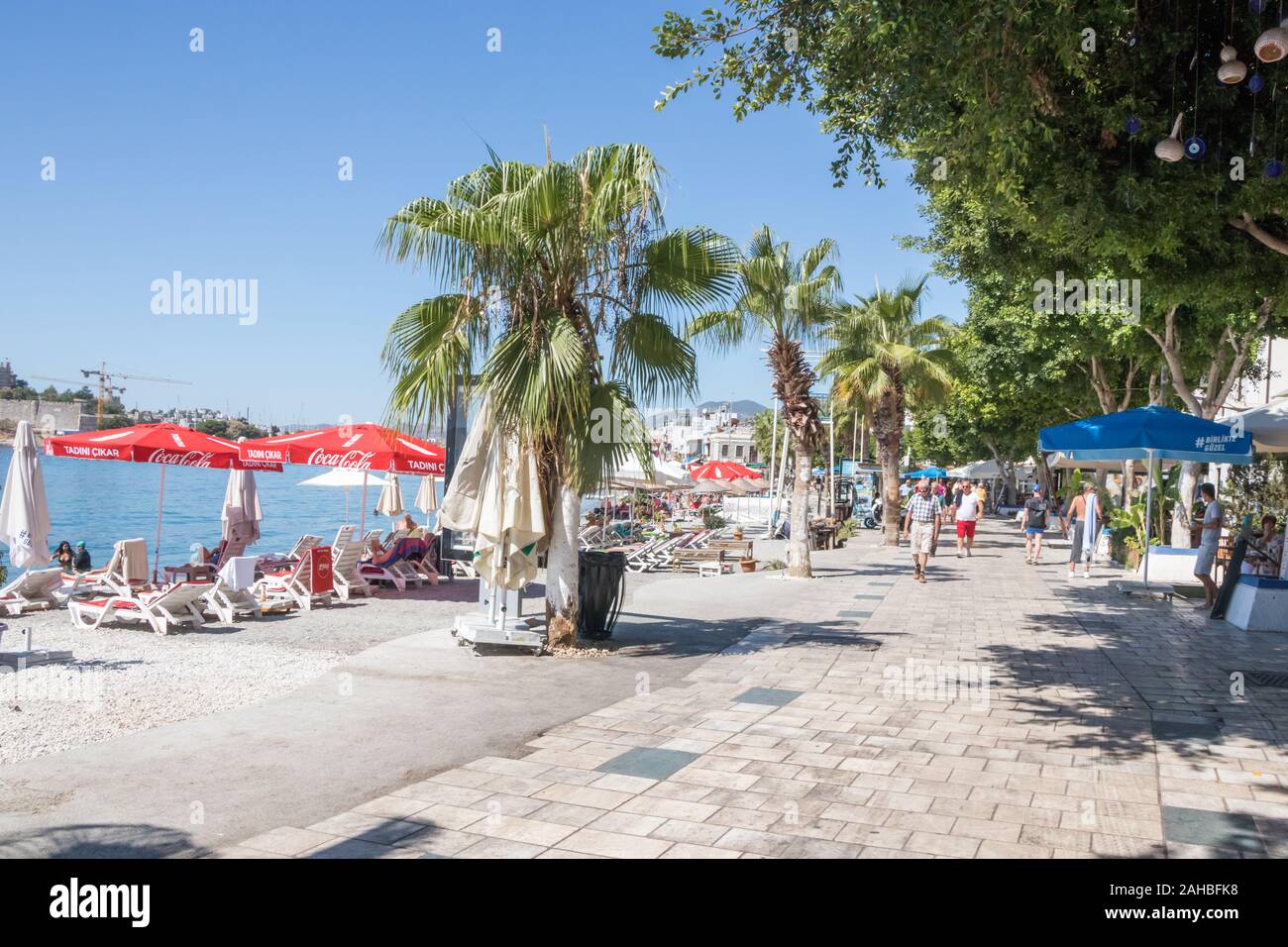 Bodrum, Turkey - September 23rd 2019: People holidaying on the beach. The town is a popular holiday destination. Stock Photo