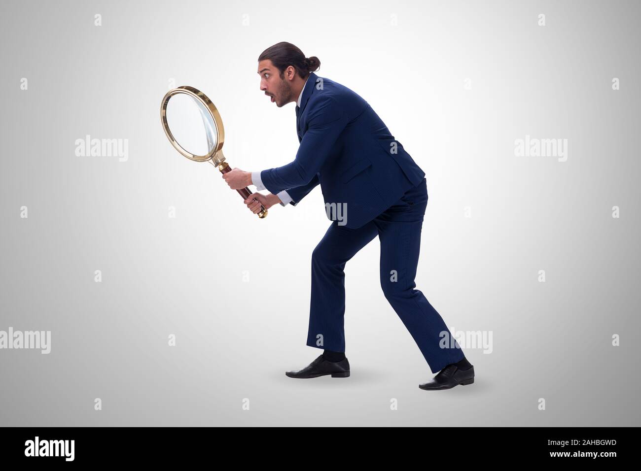 The businessman with giant magnifying glass Stock Photo Alamy