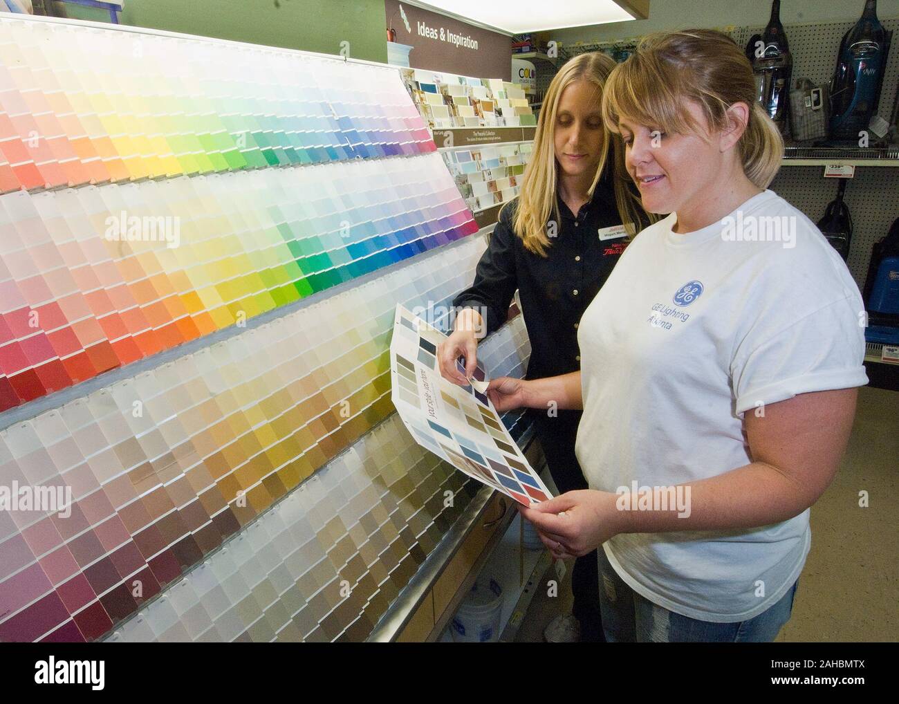 Megan Mentzer (left) assists Jaylene Hicks with a paint color selection for her home in Newton’s Tru-Value Hardware Store in Cherryvale, Kansas. Mentzer was able to acquire a Rural Business Economic Grant from the U. S. Department of Agriculture, Rural Development, Rural Business with funding available through American Recovery and Reinvestment Act of 2009 (ARRA). Stock Photo