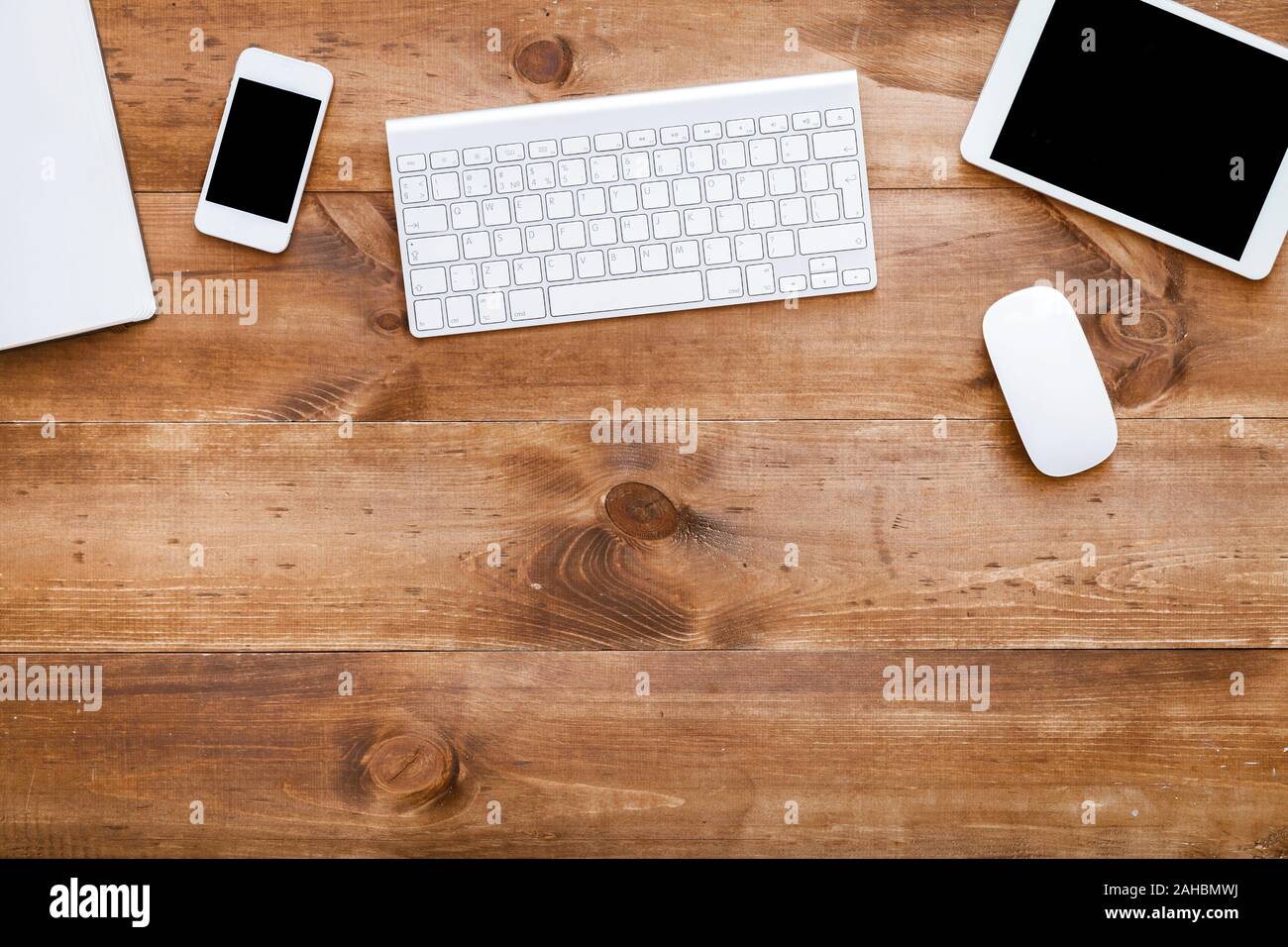 Business devices on wooden desk modern office background, top view Stock Photo