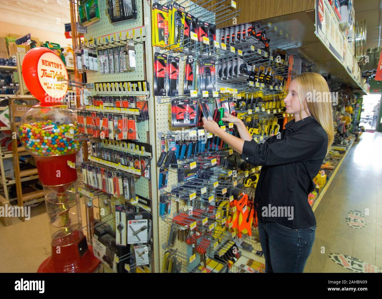 Megan Mentzer arranges tools on a rack in Newton’s Tru-Value Hardware Store in Cherryvale, Kansas. Mentzer is a fourth generation owner of the hardware store and the President of the Cherryvale Chamber of Commerce. Mentzer was able to acquire a Rural Business Economic Grant from the U. S. Department of Agriculture, Rural Development, Rural Business with funds allocated through the American Recovery and Reinvestment Act of 2009 (ARRA). 09di1526-08 Stock Photo