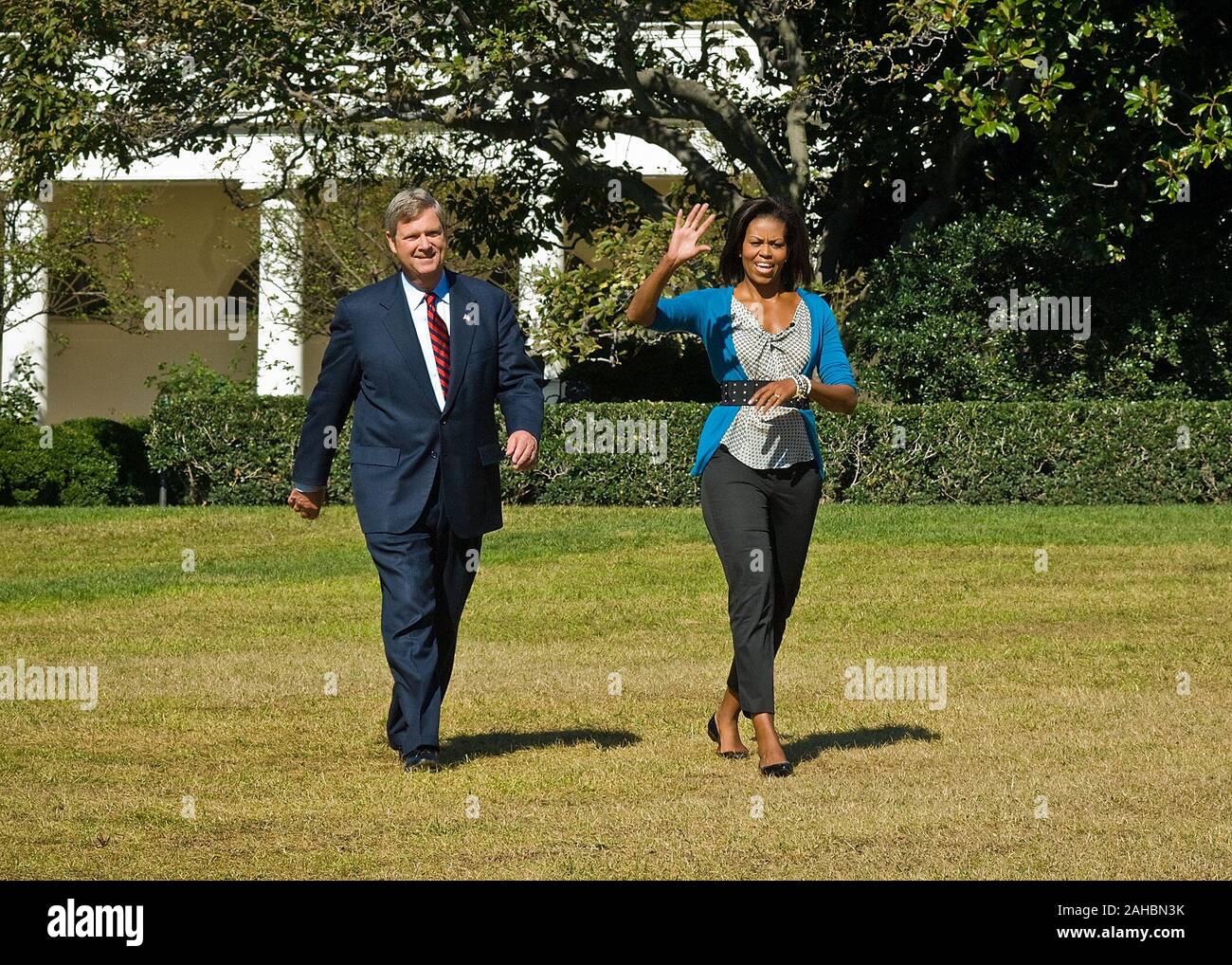 First Lady Michelle Obama and Agriculture Secretary Tom Vilsack stroll across the South lawn of the White House before announcing the Obama Administration is expanding the Healthier US School Challenge. Congress is currently considering the Childhood Nutrition Reauthorization legislation, which impacts the National School Lunch and Breakfast programs. Vilsack cited the importance of proposals to eliminate barriers that impact the health and nutrition of our children. Stock Photo