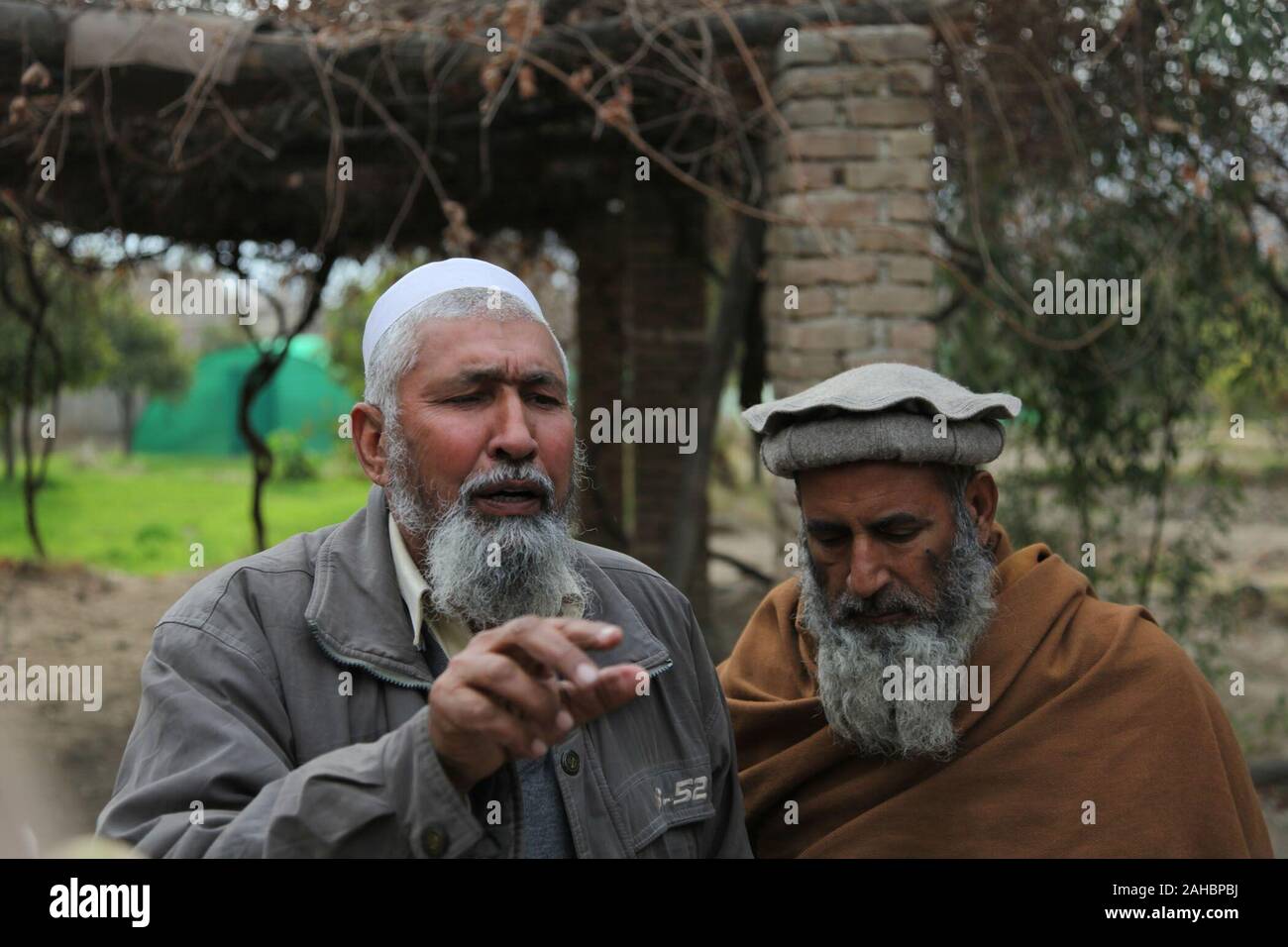 Live stock specialist Mohamed Nasor and Dr. Mohamed Yusin of the Afghan Department of Agriculture talk about future development of green houses, and other agricultural technology, in Qarghayee District, at Laghman province, Afghanistan, Jan. 27, 2010. Stock Photo