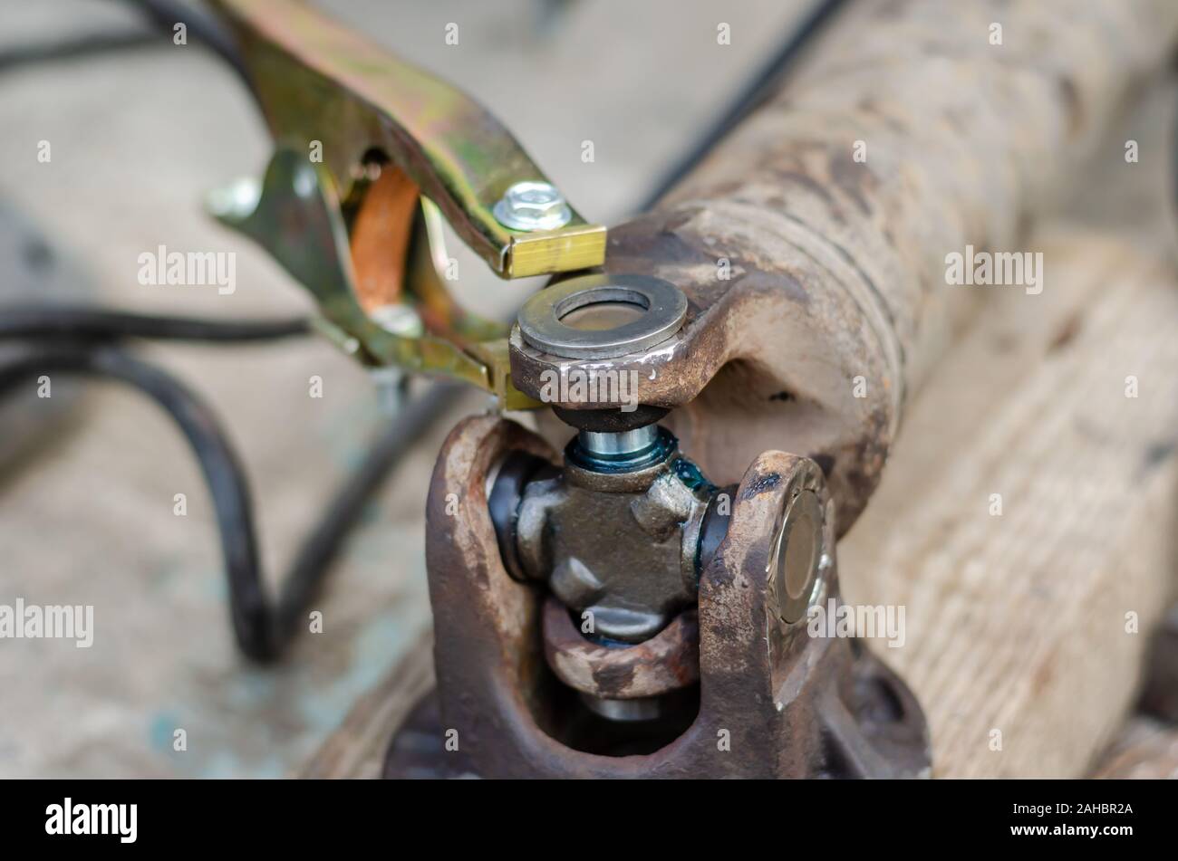 Closeup of the driveshaft of a truck with a new replaced cross