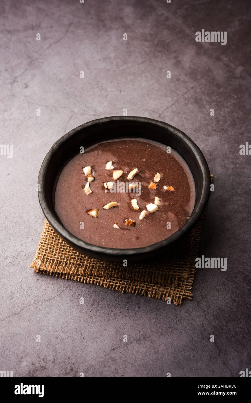 Sweet Ragi Malt / Healthy Ragi Porridge in a bowl garnished with ...