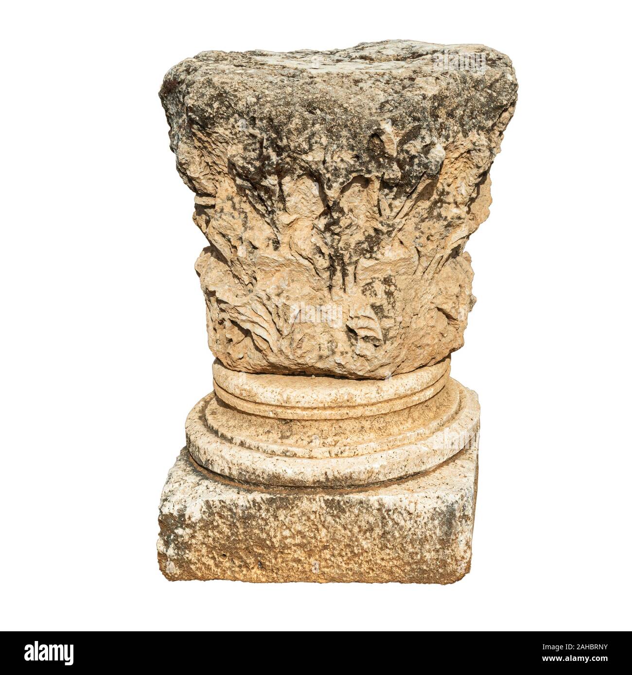 isolated cutout of an ancient greek corinthian style capital on a white background found at Hermon Stream National Park in Israel Stock Photo