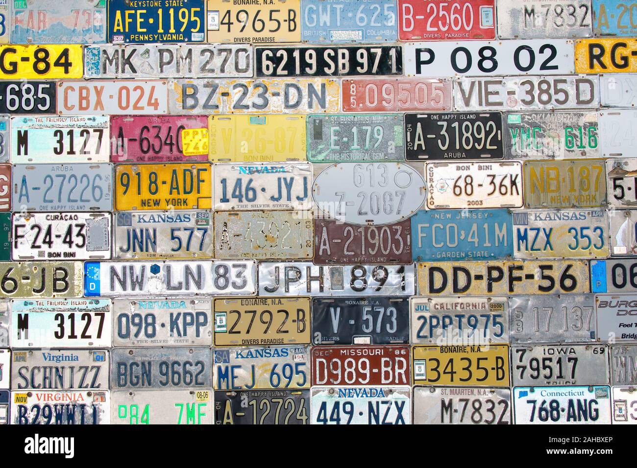 Background with rows of different license plates from many states and coutries Stock Photo