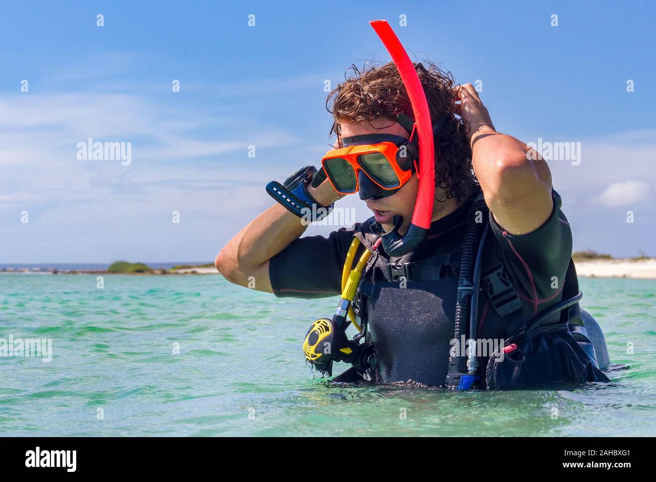 Close up young caucasian diver standing in sea Stock Photo