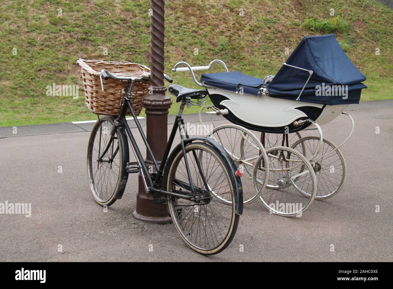 A Vintage Baby Pram and a Ladies Pedal Bicycle. Stock Photo