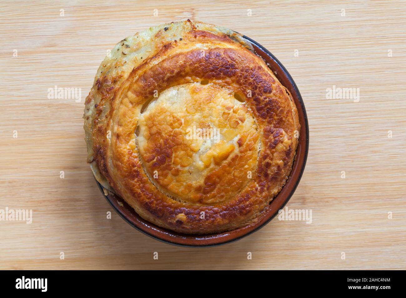 pulled ham & cheese piggy pie from M&S food collection set on wooden background Stock Photo