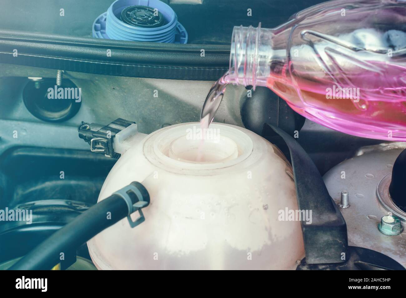 Car engine filling with coolant Stock Photo