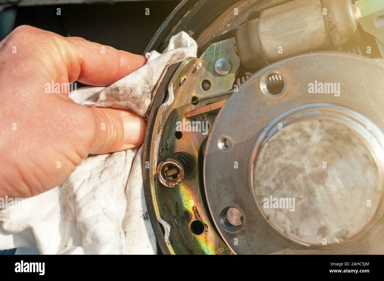 Car drum brake cleaning with rag Stock Photo