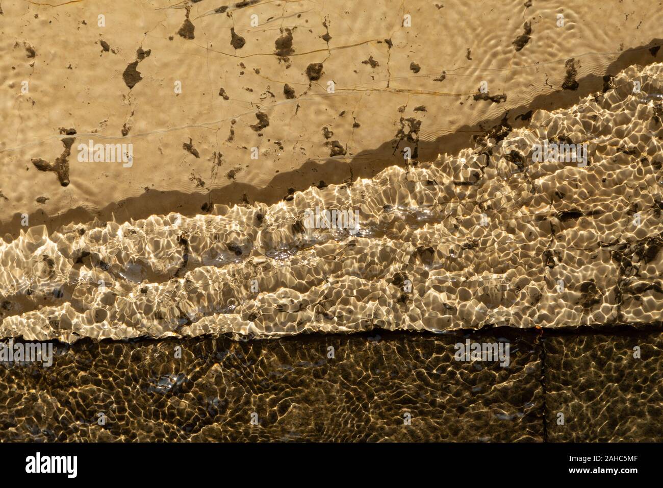 pattern of water ripples over pavement Stock Photo - Alamy