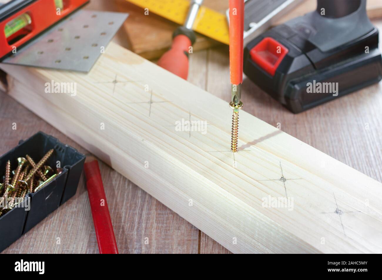 Screwing screw into wood with screwdriver Stock Photo Alamy