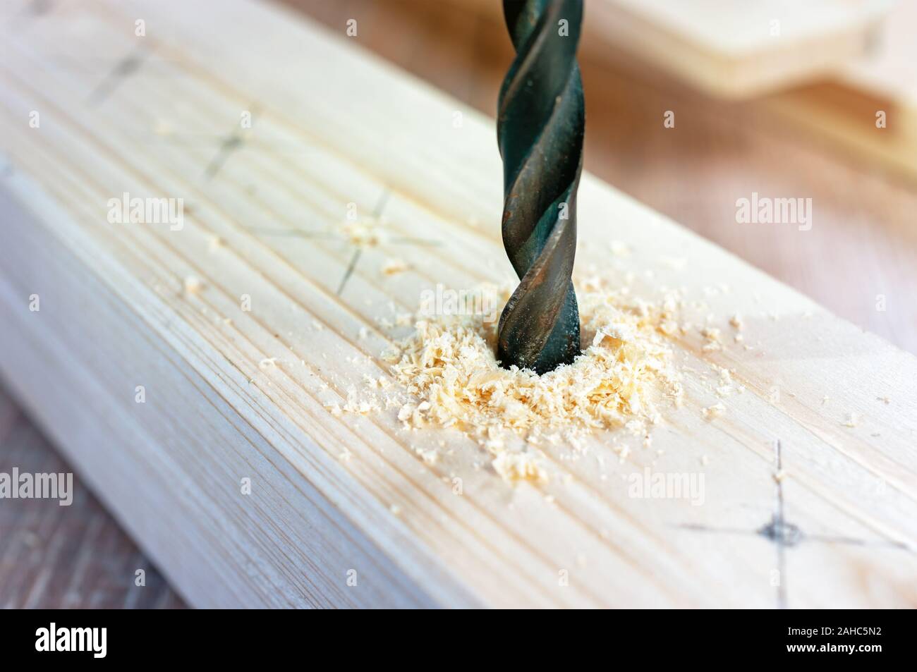 Making hole into the wood with drill bit Stock Photo