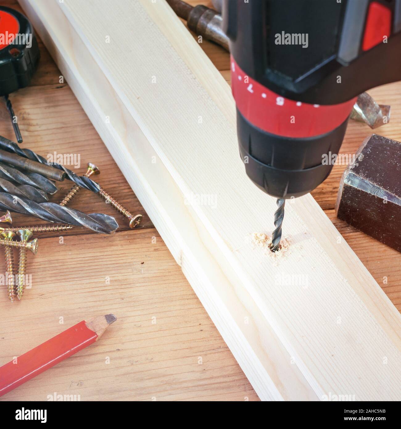 Drill work. Making hole into the wood with drill bit Stock Photo Alamy