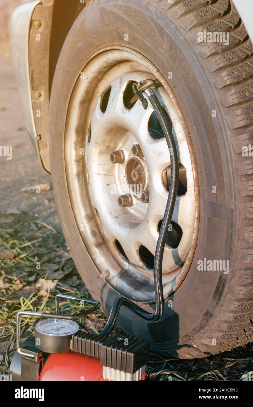 Car tire inflate with compressor Stock Photo
