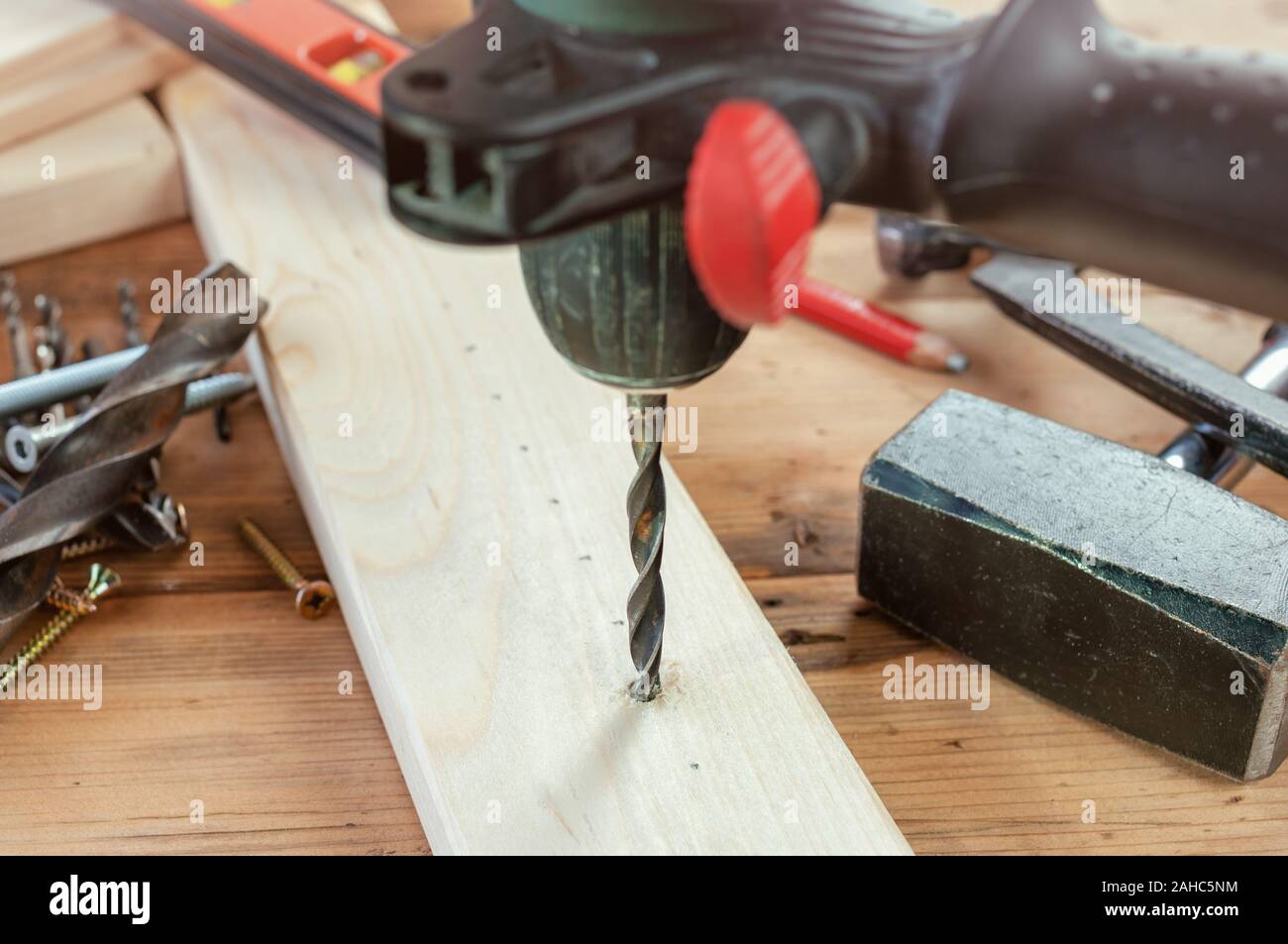 Drill work. Making hole into the wood with drill bit Stock Photo