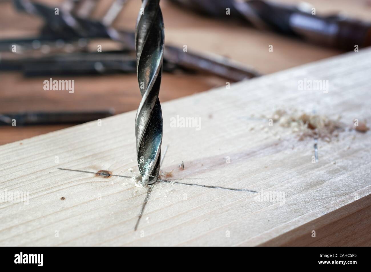 Drill work. Making hole into the wood with drill bit Stock Photo
