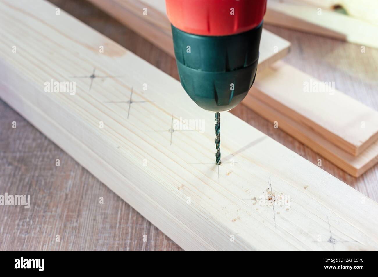Making hole into the wood with drill bit Stock Photo
