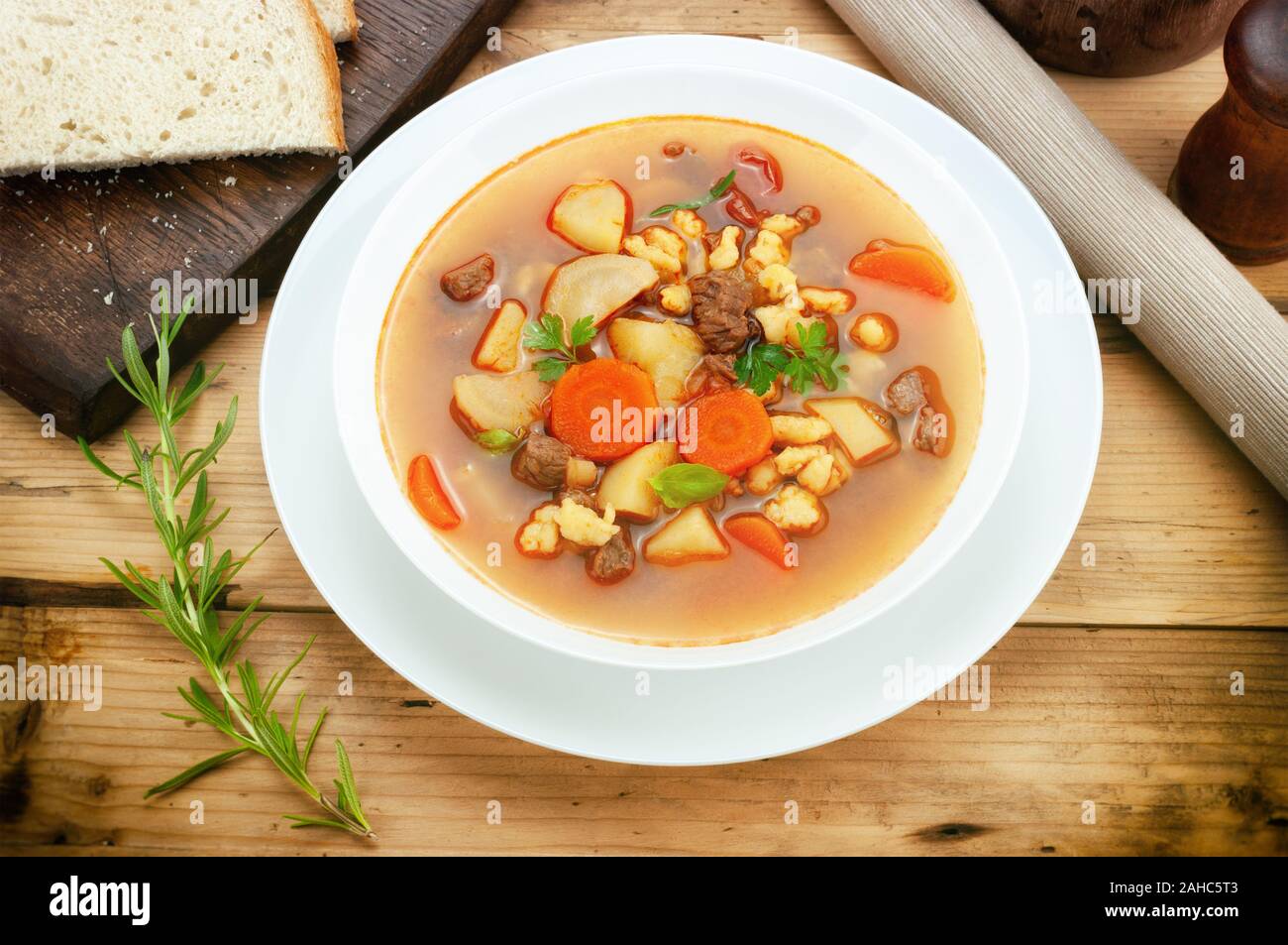 Goulash soup on wooden table Stock Photo