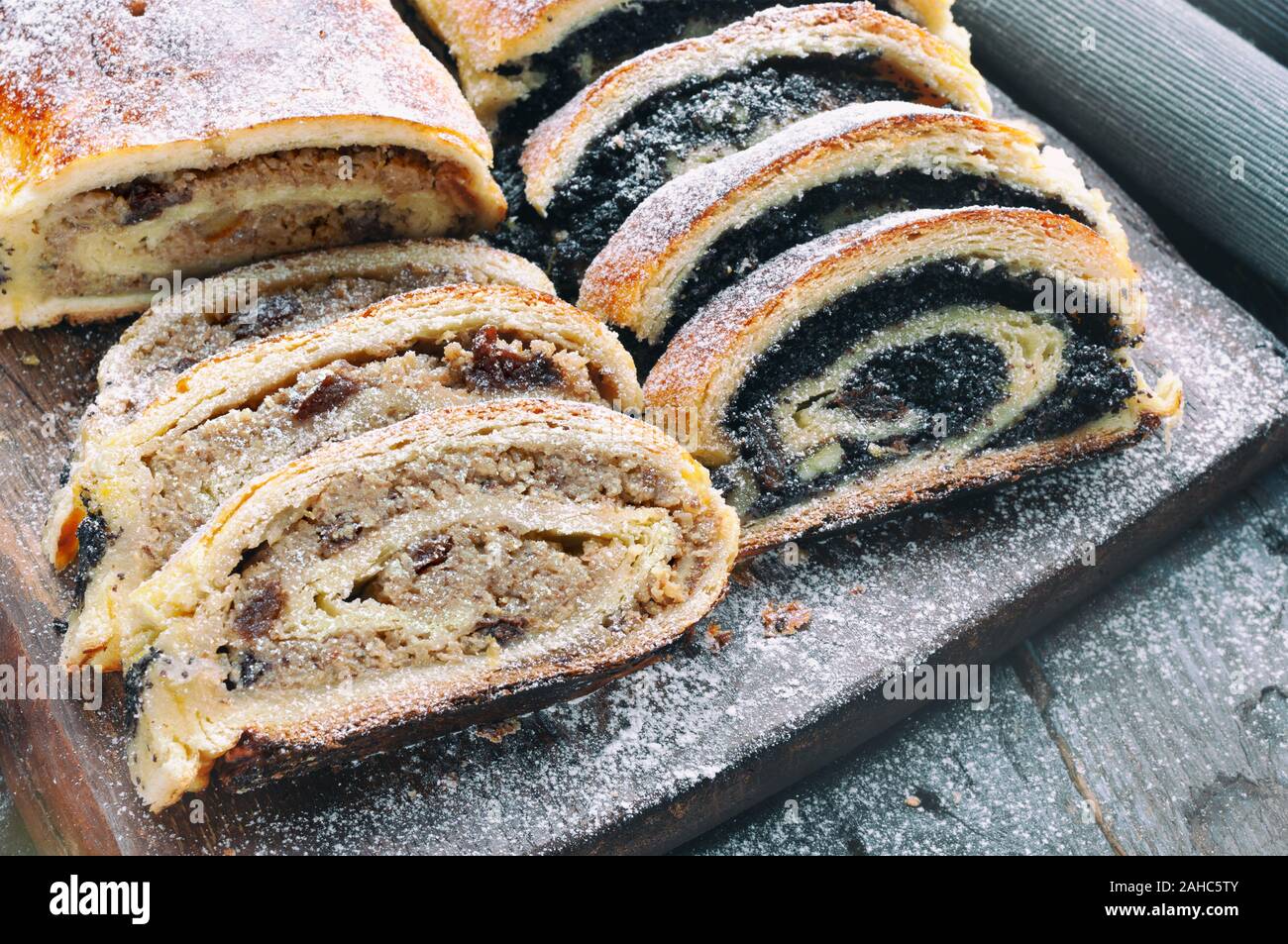 Poppy seed roll and wallnut roll on wooden table Stock Photo