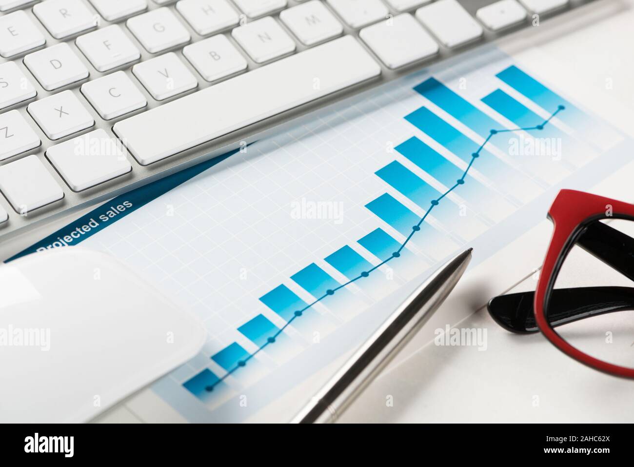 Business workplace with keyboard mouse and papers with graphs and diagrams Stock Photo Alamy