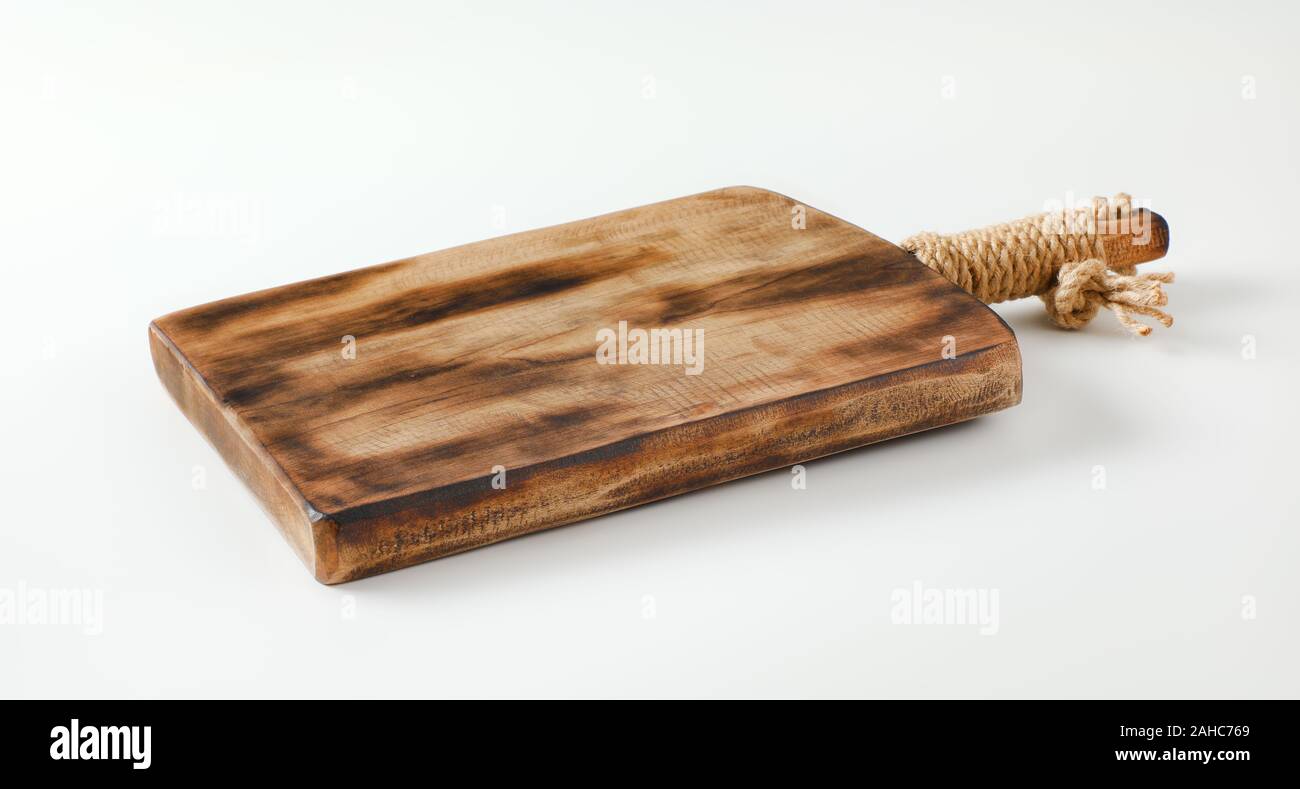 Rustic wooden cutting or serving board with handle Stock Photo