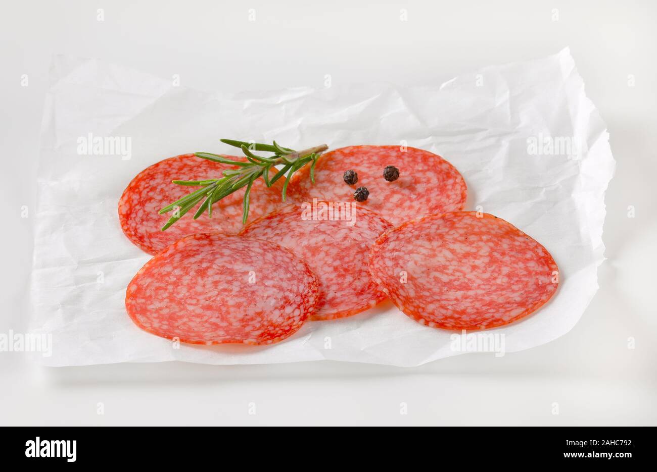 Download Sliced Salami Sausage On White Wax Paper Stock Photo Alamy PSD Mockup Templates