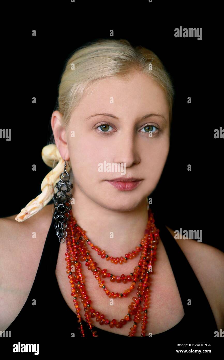 Portrait of girl with Boa constrictor albino snake on head. Woman with ...