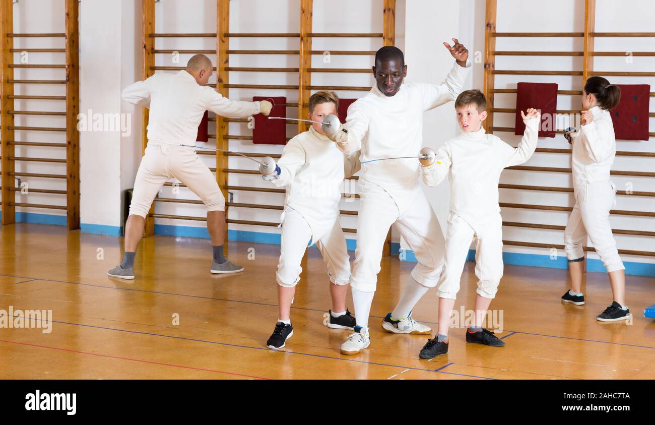Fencing Training Roon Fencing instructor explaining to young fencers effective movements and ...