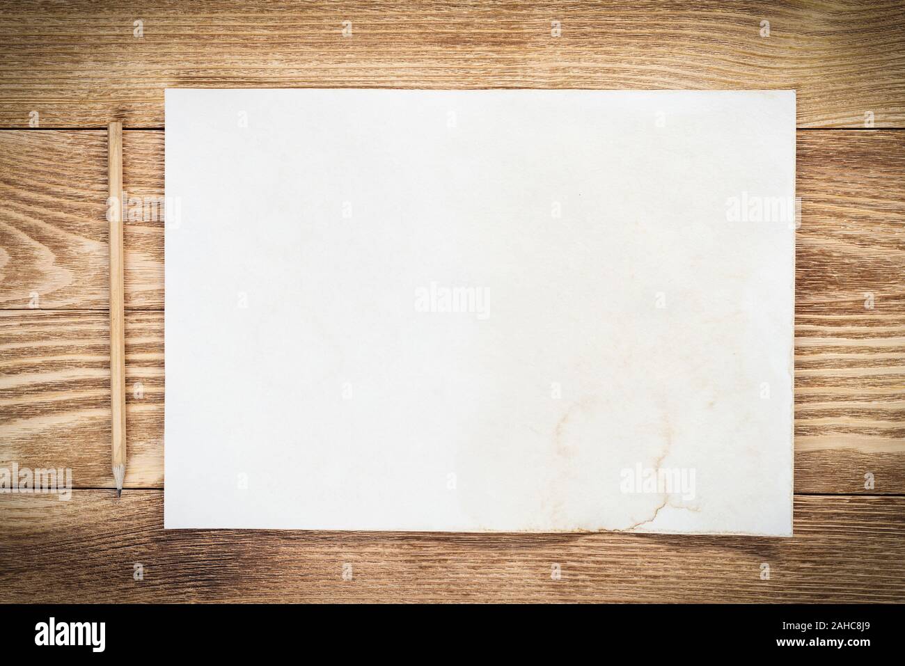 Business workspace with sheet of paper and pencil lying on wood table ...