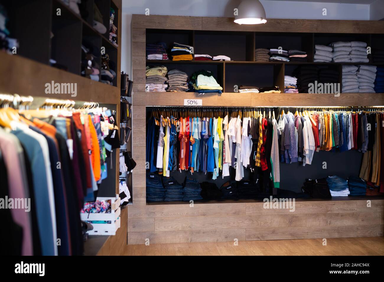 Men clothing shop, casual clothes on hangers and shelves in