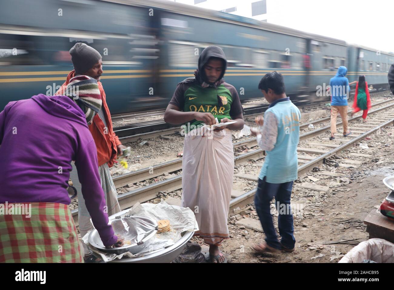 A street hawker 21dec2019,Dhaka Bangladesh is standing teagoan railway station and waiting for his customer. © Nazmul Islam/alamay live news Stock Photo