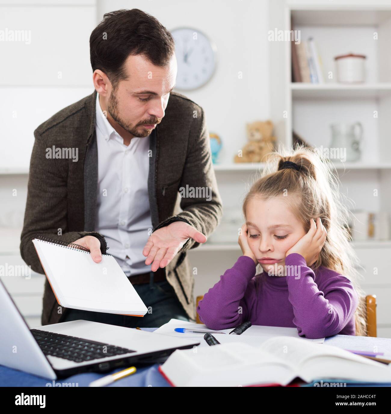 Father helping his child to do homework at home Stock Photo - Alamy