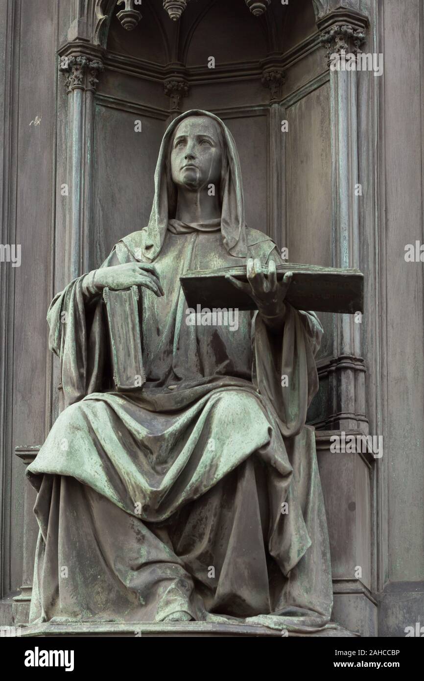 neo-gothic statue of woman holding book Stock Photo