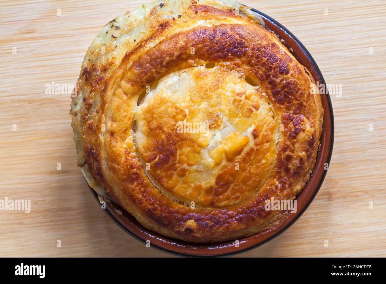 pulled ham & cheese piggy pie from M&S food collection set on wooden background Stock Photo