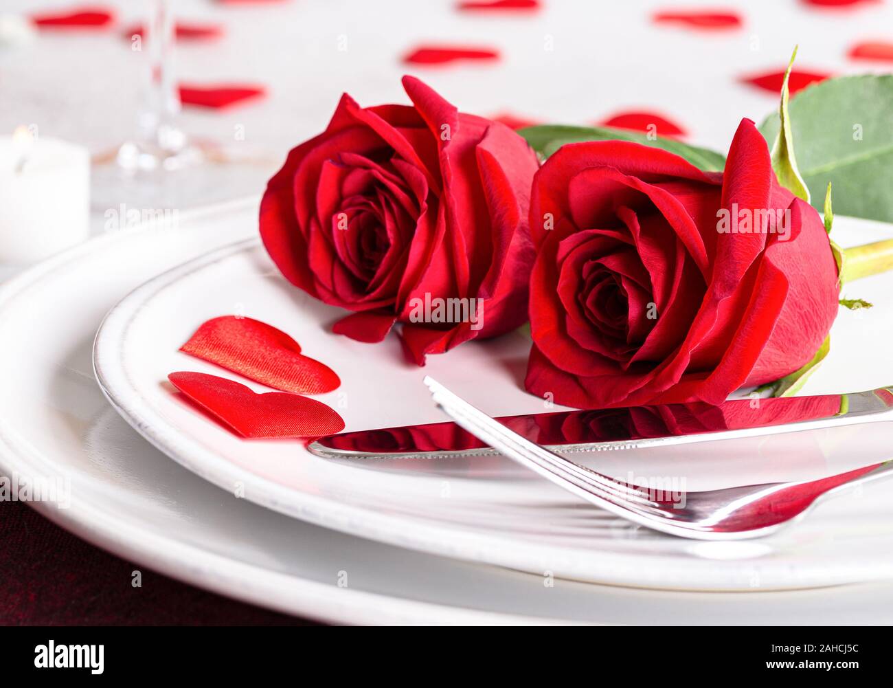 Closeup of Two Red Roses on a table setting for Valentines Day Stock ...