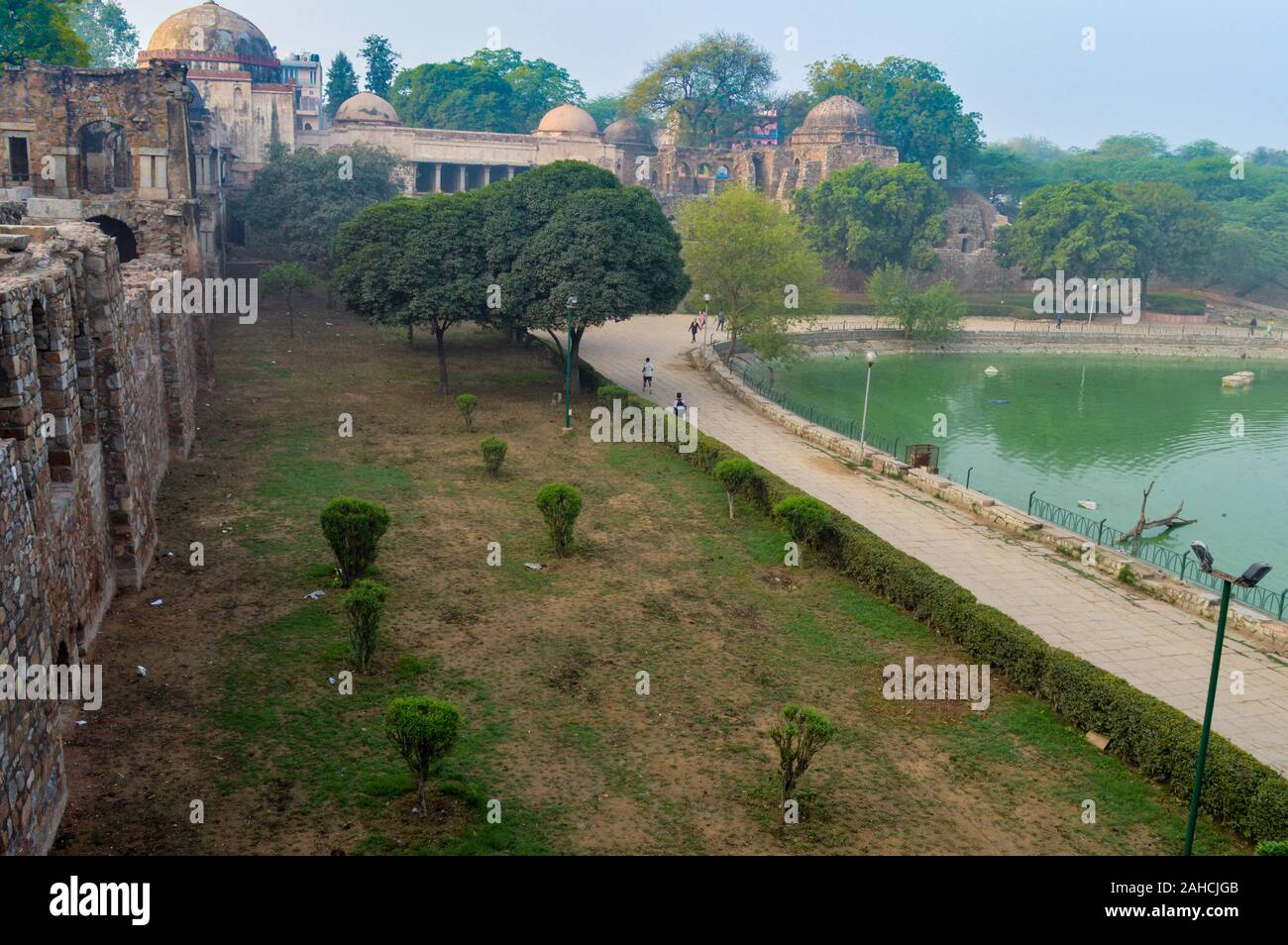 A mesmerizing view of hauz khas lake and garden from the hauz khas fort at hauz khas village at winter foggy morning. Stock Photo