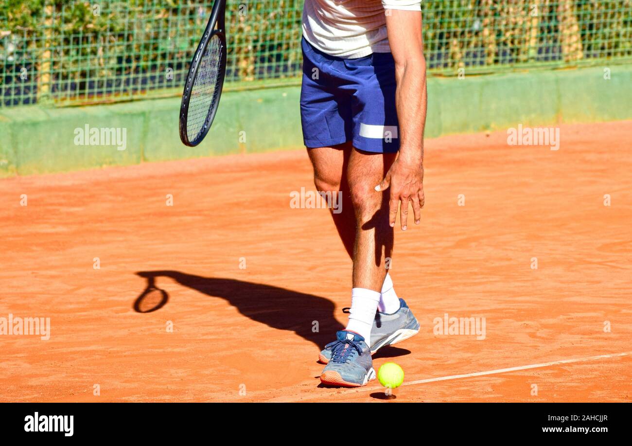 Unknown Tennis player playing a professional tennis match in clay court. Stock Photo