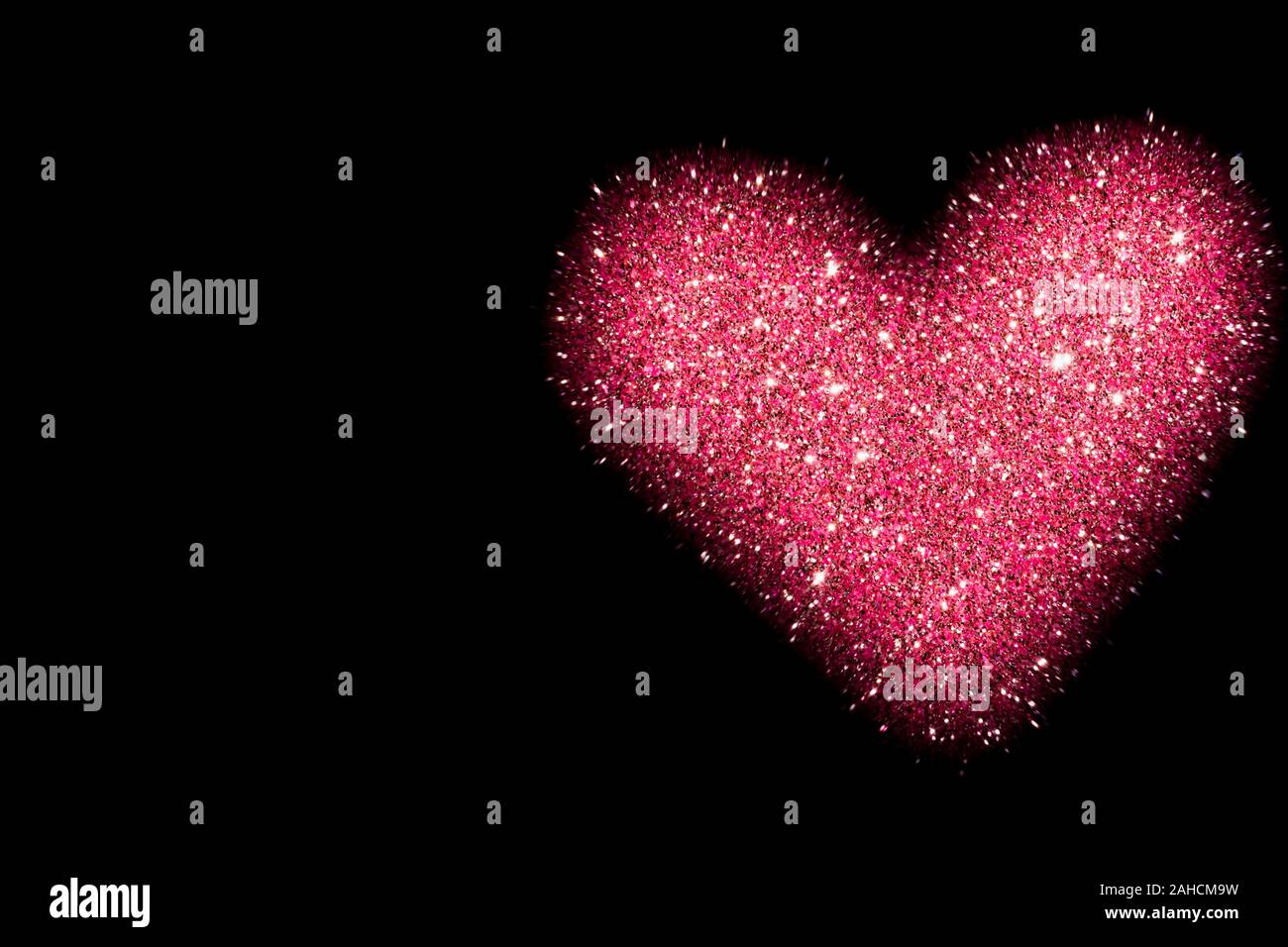 abstract background with pink heart isolated on black, shiny heart with  glitter effect Stock Photo - Alamy