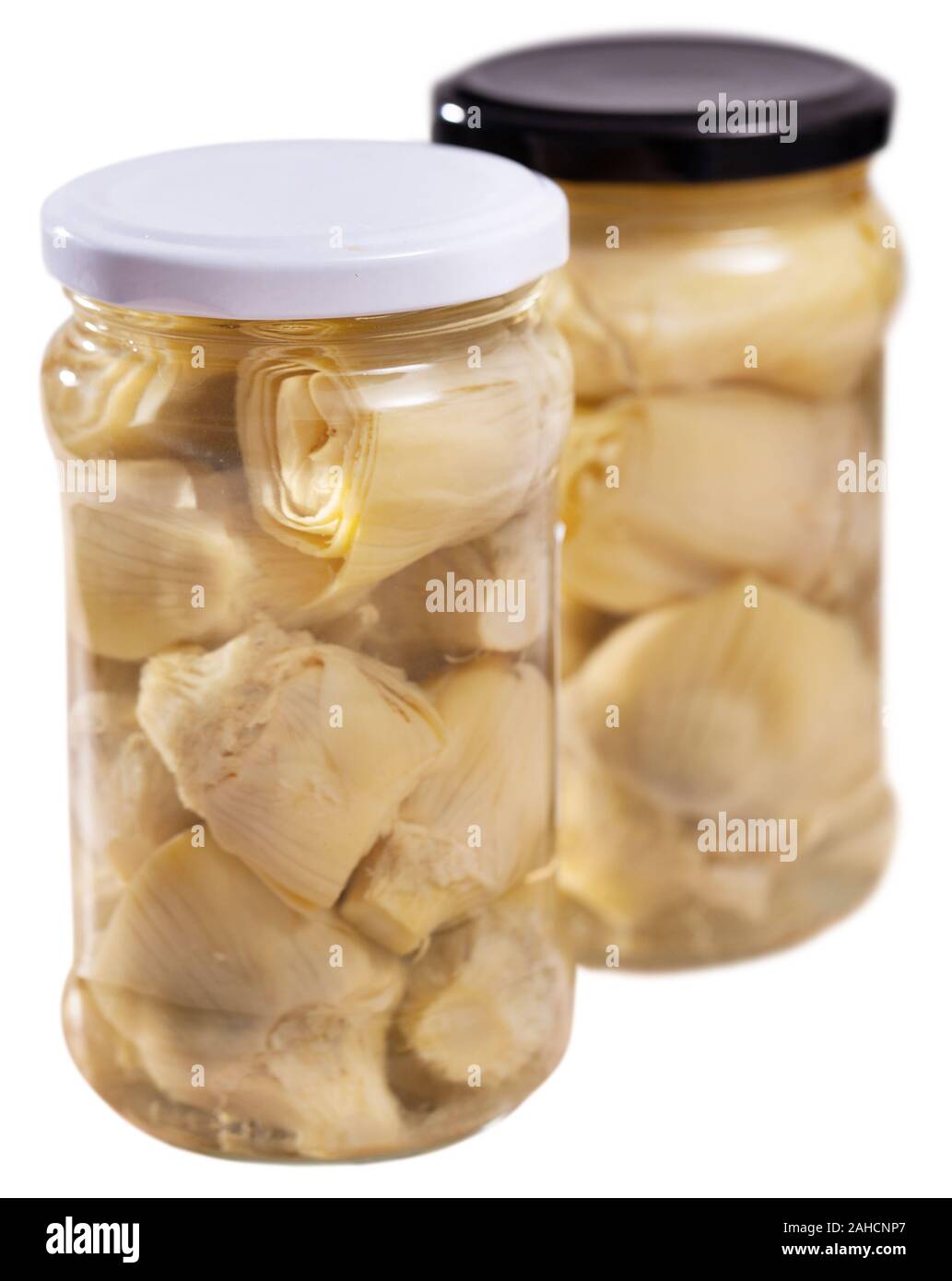 Marinated artichokes in glass jar, preserved or canned food. Isolated