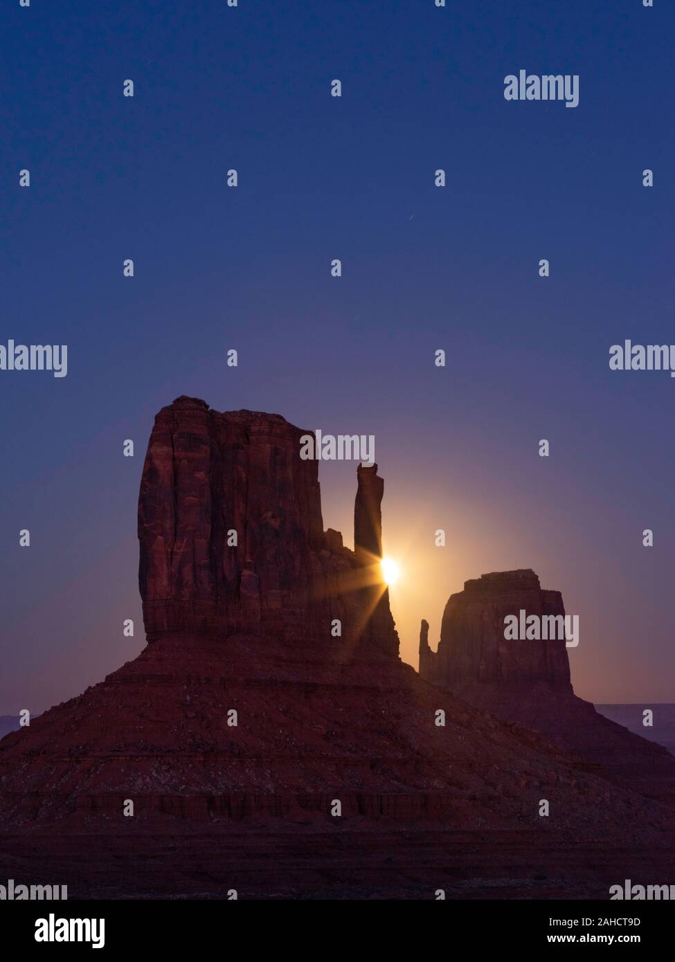 Hunter's Moon rising behind the West Mitten, Monument Valley, Arizona Stock Photo