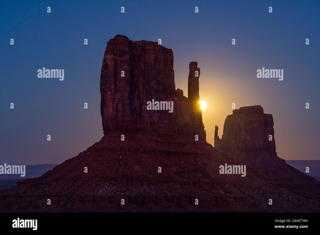 Hunter's Moon rising behind the West Mitten, Monument Valley, Arizona Stock Photo