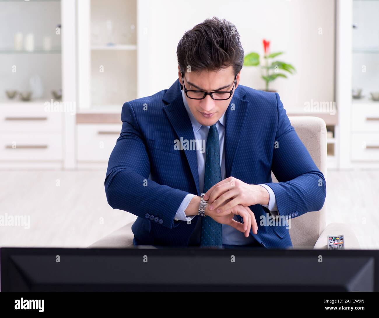 The businessman watching tv in the office Stock Photo