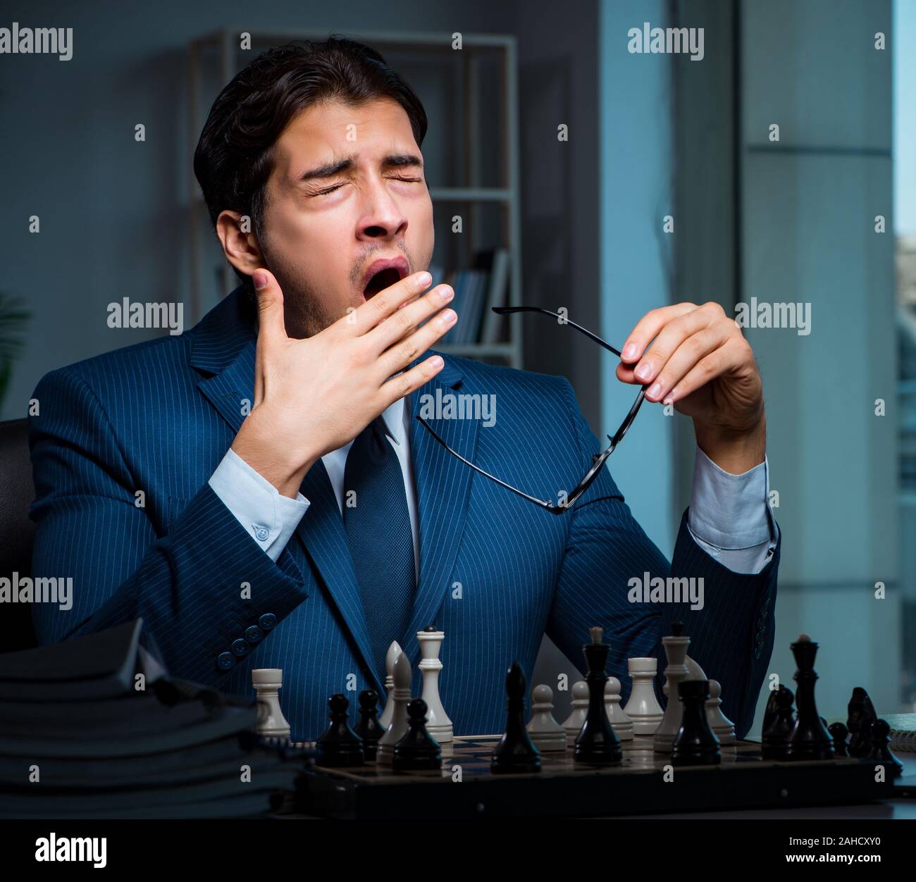 The businessman playing chess in strategy concept Stock Photo - Alamy